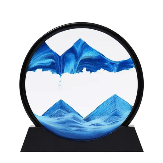 Décoration intérieure sable OneScale avec sable bleu formant des montagnes dans un cadre rond moderne